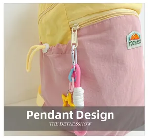 Close-up of color-block backpack with yellow star pendant and textured nylon fabric detail