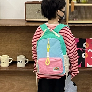Kids color-block backpack with large capacity and stylish patchwork design on a child model