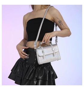 Close-up of a silver holographic laser messenger bag with chic metallic cracked texture