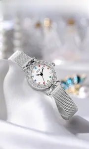 Close-up of silver mesh strap watch with colorful gemstone indices on white dial