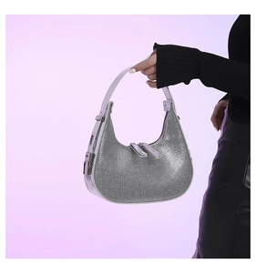 Close-up of silver sequin crescent hobo bag showing sparkling texture and metal hardware