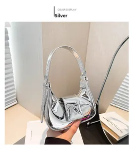 Detail of silver metallic Y2K mini handbag with decorative bow and glossy finish