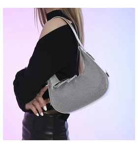 Detailed view of silver rhinestone hobo bag with sparkling crystals and leather strap