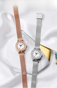 Detail view of rose gold and silver mesh band watches with colorful dial markers