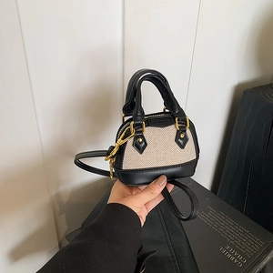 Mini shell bag in black leather and beige canvas patchwork with elegant gold zippers