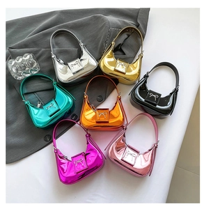 Row of mini metallic handbags with bow details in silver gold green and pink colors