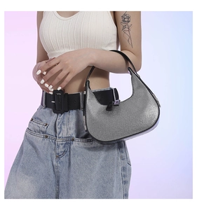 Detail of silver glitter crescent hobo bag with black zipper and sleek metallic finish