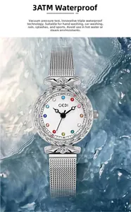 Close-up of women's silver mesh watch with crystal hour markers splashing in water
