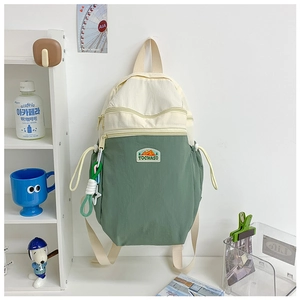 Detail of contrast color school backpack with multi-layer zippers and drawstring side pocket