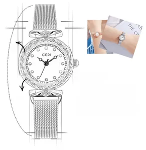 Detail of silver mesh strap watch featuring twelve colorful gemstone hour markers