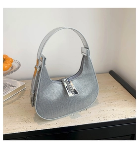 Close-up of sparkling silver rhinestone hobo bag with dual metal zipper detail