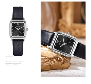 Detail of vintage square quartz watch with black leather strap and textured dial