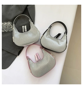 Three sequined crescent hobo bags in silver with black, white and pink trim details