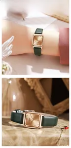 Detail of elegant square rose gold watch featuring a green leather strap and gold sunray dial