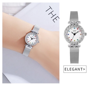 Detailed shot of engraved silver bezel and colorful gemstone markers on a mesh watch