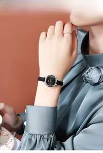 Detail of elegant ladies' quartz watch with sunray dial and sleek leather strap