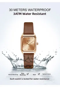Detail showing 3ATM water resistance of rectangular gold watch with brown leather strap