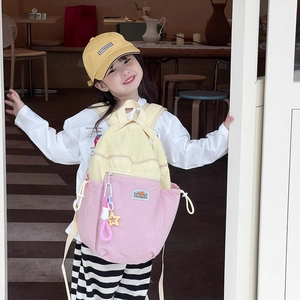 Vibrant yellow and pink color-block kids backpack with cute charms and large capacity