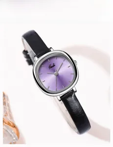 Detailed view of square silver watch with purple sunray dial and black leather strap
