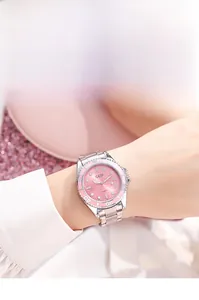 Close-up of GEDI women's watch with pink sunray dial and silver metal strap on wrist