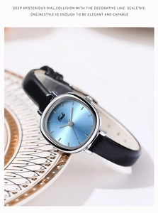 Detail of square silver quartz watch with light blue dial and black leather strap