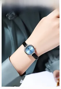 Close-up of elegant women quartz watch with blue gradient dial and black leather strap