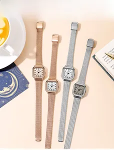 Flat lay of square stainless steel mesh strap watches with elegant minimalist dials