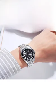 Close-up of a stylish men's waterproof quartz watch with a black dial on a male wrist