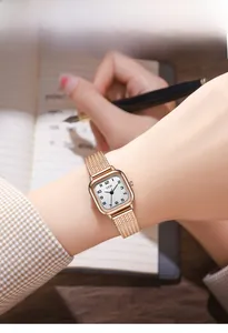 Chic lifestyle view of gold square quartz watch with Milanese band on a woman's wrist