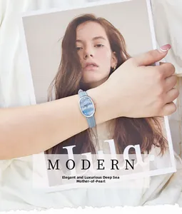 Detail of an oval quartz watch featuring a dark blue mother-of-pearl dial and blue leather strap