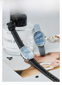Detail of Gedi quartz watch with oval silver case and colorful mother-of-pearl dial