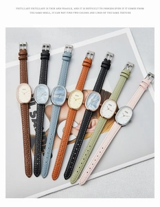 Macro shot of seven colored leather strap quartz watches with elegant oval dials