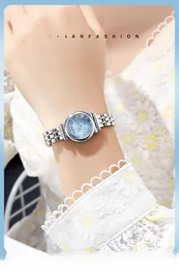 Close-up of a vintage Roman dial silver steel strap watch on a woman's wrist