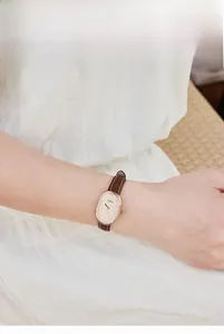 Detail of GEDI oval women's quartz watch with rose gold case and brown leather strap