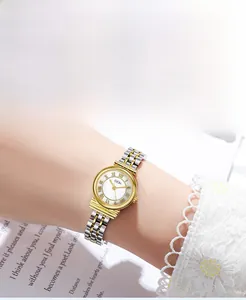 Close-up of GEDI vintage quartz watch with gold roman dial and two-tone steel strap