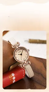Detail of rose gold case with spark pattern dial and rhinestone accents on leather strap