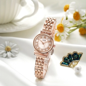 Close-up of rose gold watch with Roman numeral dial on elegant white silk background