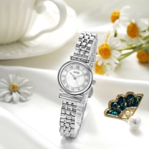 Detail of elegant steel watch with Roman dial on white silk with flowers