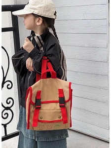 Detail view of children's vintage canvas backpack featuring cartoon bear and rabbit prints