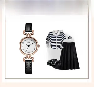 Close-up of minimalist women's watch with rose gold case and black leather strap for outfit matching