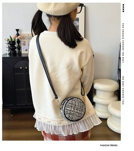 Girl's round crossbody bag in black and white tweed with golden hardware detail