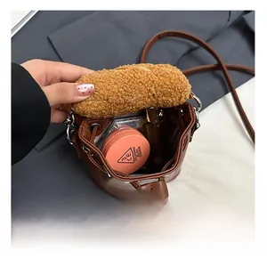 Detail showing the inner capacity of brown leather and plush bucket bag with drawstring