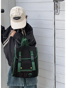 Detail view of durable canvas kids backpack with green straps and animal embroidery