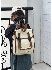Detail of vintage canvas kids backpack with contrast trim and cute animal prints