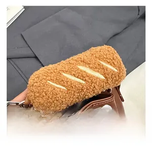 Detail view of brown plush baguette-shaped handle wrap with silver metal spring hook