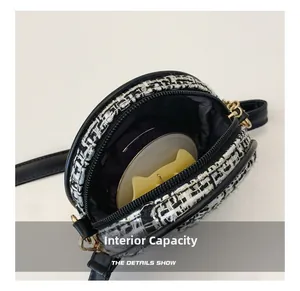 Detail show of tweed round mini purse interior with golden hardware and black strap