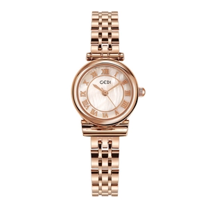 Macro view of rose gold women watch with pearl dial and Roman numeral markers