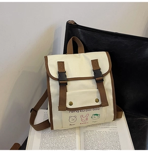 Detail of canvas kids backpack featuring vintage color-block design and animal prints