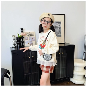 Close-up of a stylish mini round woven bag accessory on a girl cute outfit set