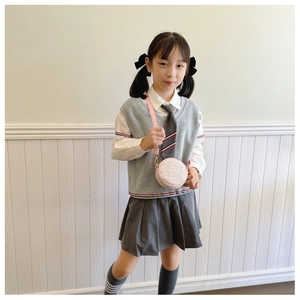 Detail of pink tweed round shoulder bag paired with gray preppy style school uniform